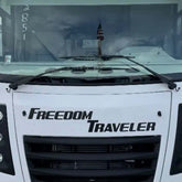 Front view of a vehicle with 'Freedom Traveler' branding on the windshield.